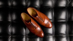 A Pair of Brown Oxford Shoes on Black Surface