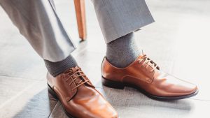 Person Sitting and Wearing Dress Pants and Shoes