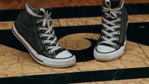 Person Wearing Black and White Converse All Star High Top Sneakers