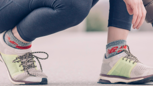 Person Wearing Gray-and-green Running Shoes