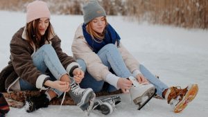 Photo of Women Putting on Ice Skating Shoes