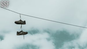 A Hanging Shoes on Cable Wire