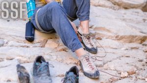 Woman Putting on Climbing Shoes