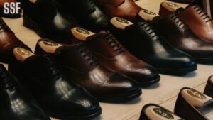 Arranged Leather Shoes on Wooden Surface