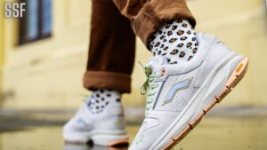 Selective Focus Photo of Person in Brown Pants and White Sneakers