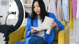 Woman Using Smart Phone to Sell Shoes