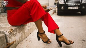 Woman Wearing Red Pants and Black Leather Ankle Strap Sandals